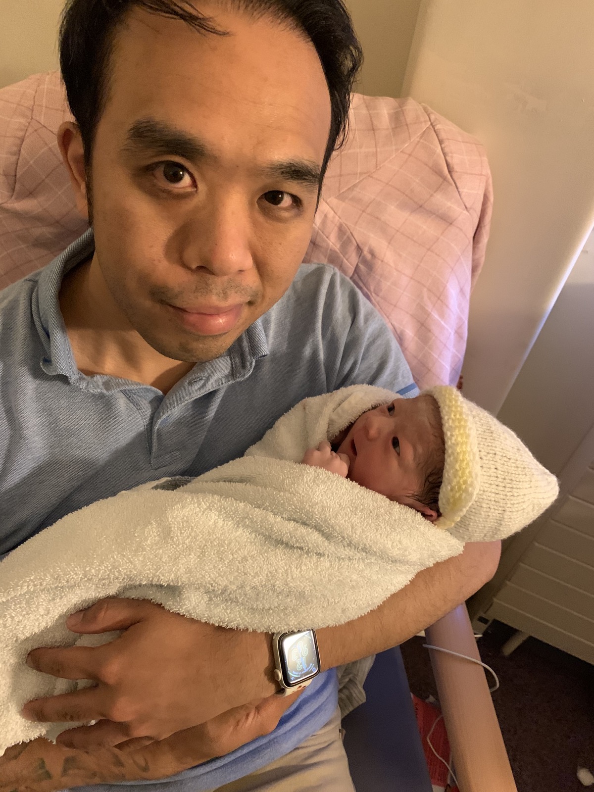 Jenkin Lee holding his newborn son Ren in April 2021
